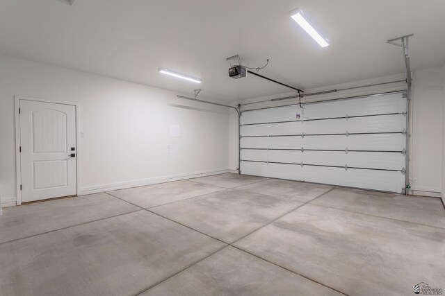 garage with baseboards and a garage door opener