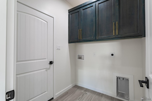 washroom with baseboards, hookup for a washing machine, light wood-style flooring, cabinet space, and hookup for an electric dryer
