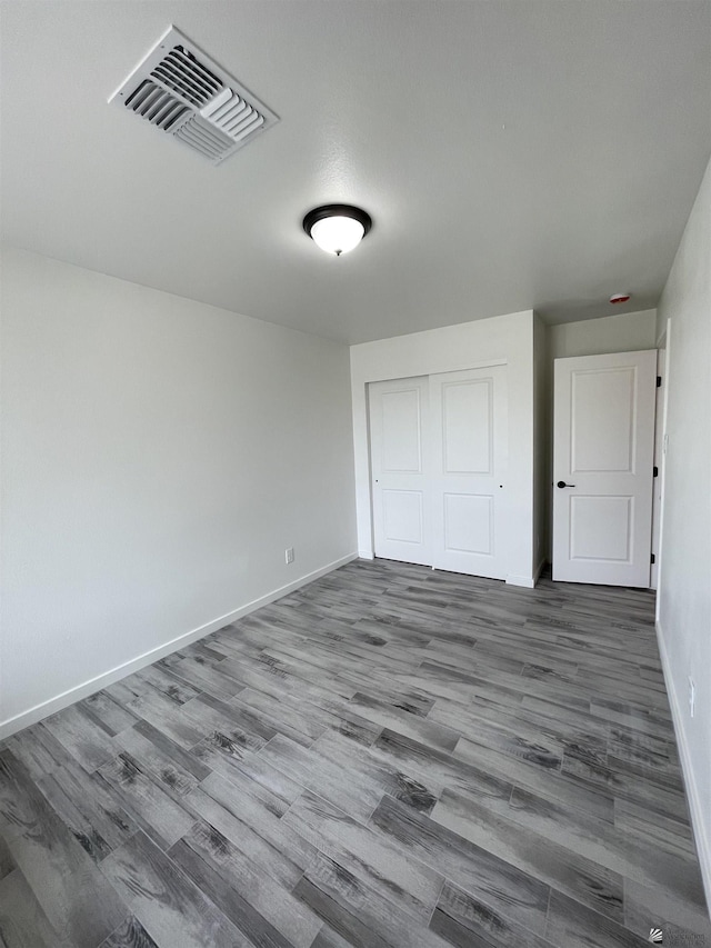 369 S 7th Ave, Yuma, AZ 85364 - unfurnished bedroom featuring wood finished floors, baseboards, and a closet