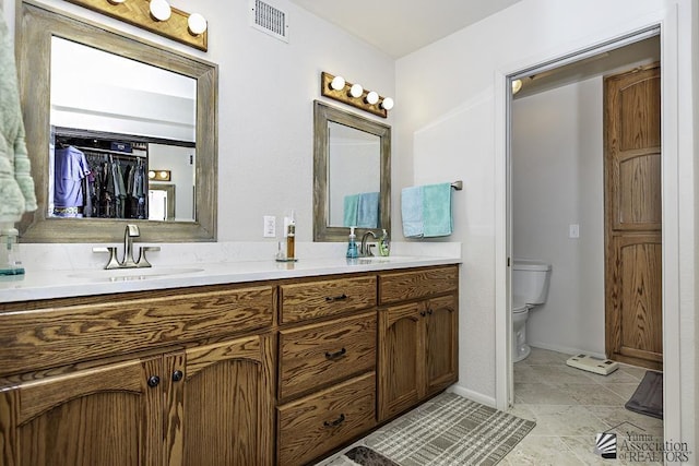 11546 E Via Montana, Yuma, AZ 85367 - bathroom featuring double vanity, toilet, visible vents, and a sink