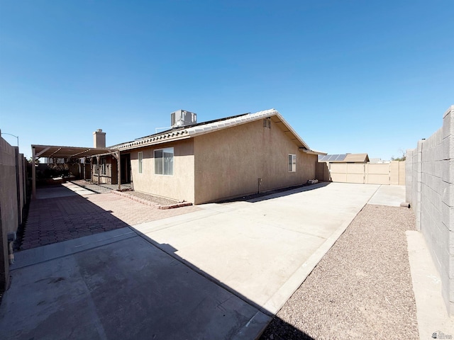 11451 E 27th Pl, Yuma, AZ 85367 - rear view of property with cooling unit, a fenced backyard, a patio area, and stucco siding