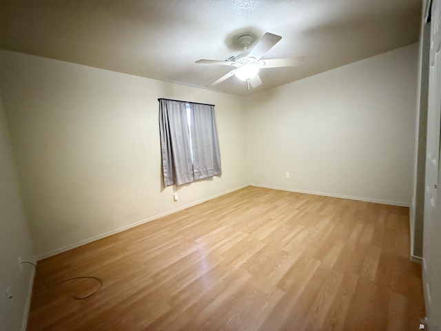 11451 E 27th Pl, Yuma, AZ 85367 - unfurnished room featuring baseboards, a ceiling fan, and light wood-type flooring