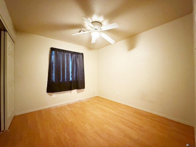 11451 E 27th Pl, Yuma, AZ 85367 - unfurnished bedroom with a closet, a ceiling fan, light wood-style flooring, and baseboards