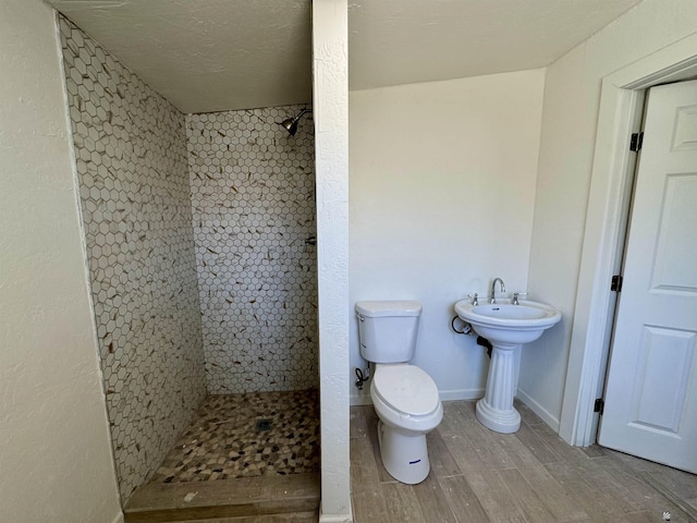 221 E Spring St, Somerton, AZ 85350 - full bath featuring tiled shower, toilet, and wood finished floors