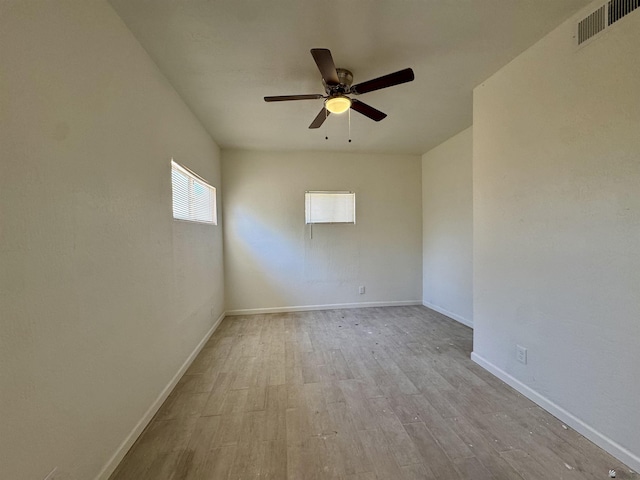221 E Spring St, Somerton, AZ 85350 - unfurnished room with wood finished floors, a ceiling fan, and baseboards
