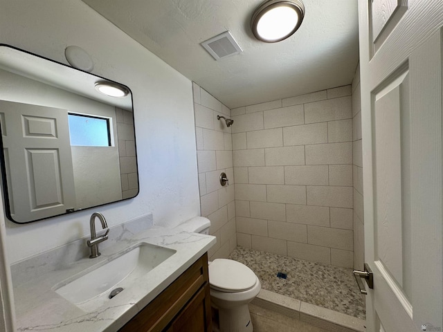221 E Spring St, Somerton, AZ 85350 - bathroom with a tile shower, toilet, vanity, and tile patterned floors