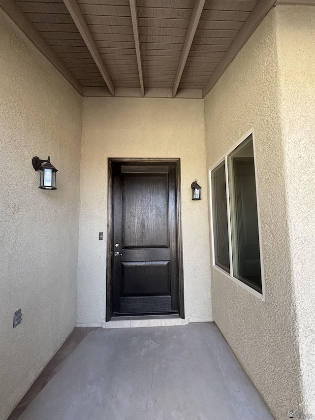 entrance to property featuring stucco siding