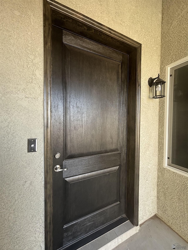 property entrance with stucco siding