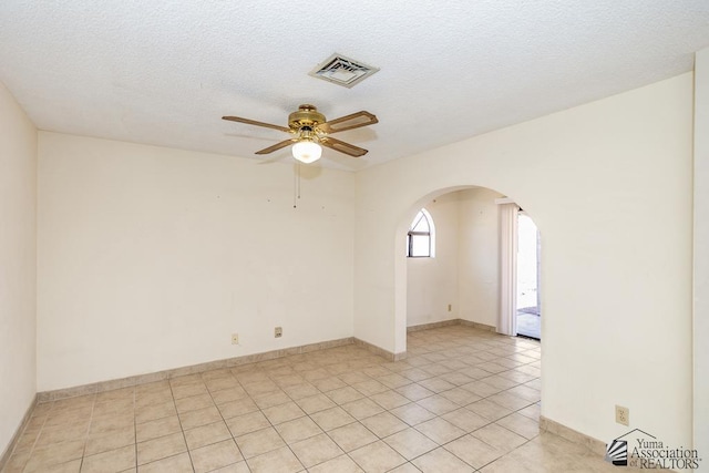 12344 E Calle Maria, Yuma, AZ 85367 - unfurnished room featuring light tile patterned flooring, arched walkways, a textured ceiling, a ceiling fan, and visible vents