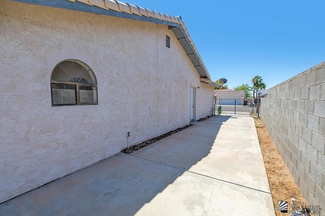 12344 E Calle Maria, Yuma, AZ 85367 - view of side of property with a patio, stucco siding, fence, and concrete driveway