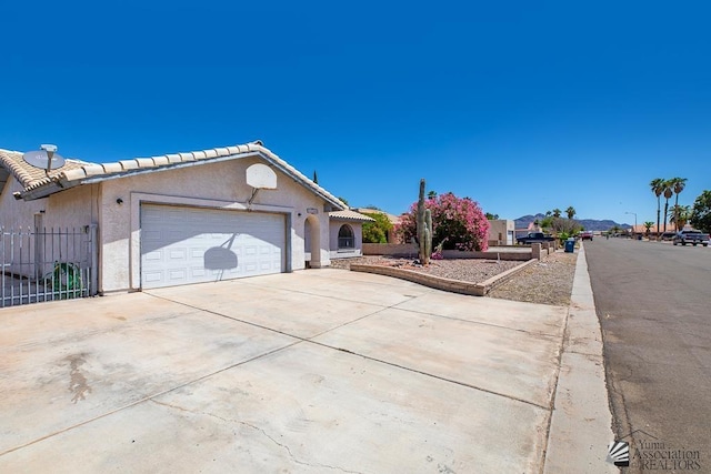 12344 E Calle Maria, Yuma, AZ 85367 - ranch-style home featuring a tiled roof, fence, concrete driveway, an attached garage, and stucco siding