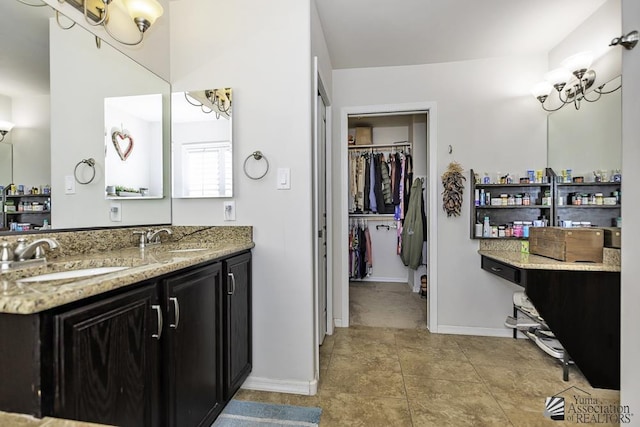 2793 S Aurora Ave, Yuma, AZ 85365 - full bath with a walk in closet, baseboards, double vanity, and tile patterned floors