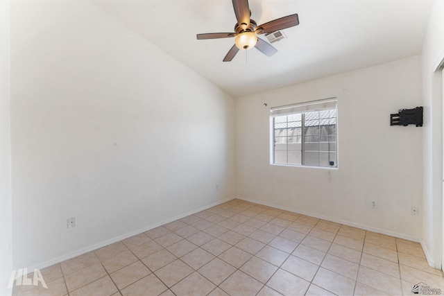 spare room featuring light tile patterned flooring, a ceiling fan, baseboards, vaulted ceiling, and visible vents