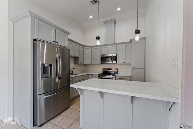 kitchen with visible vents, a peninsula, light tile patterned flooring, gray cabinetry, and stainless steel appliances