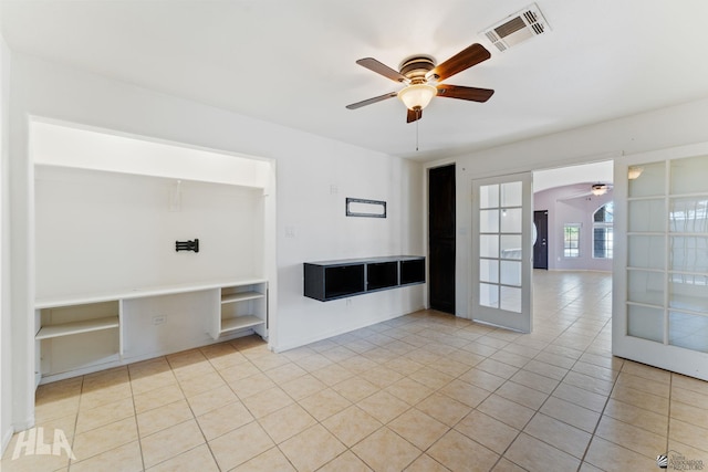 unfurnished room with ceiling fan, light tile patterned flooring, and visible vents