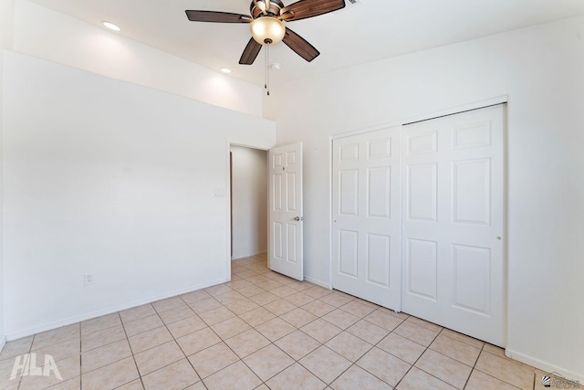 unfurnished bedroom with a closet, baseboards, and light tile patterned flooring
