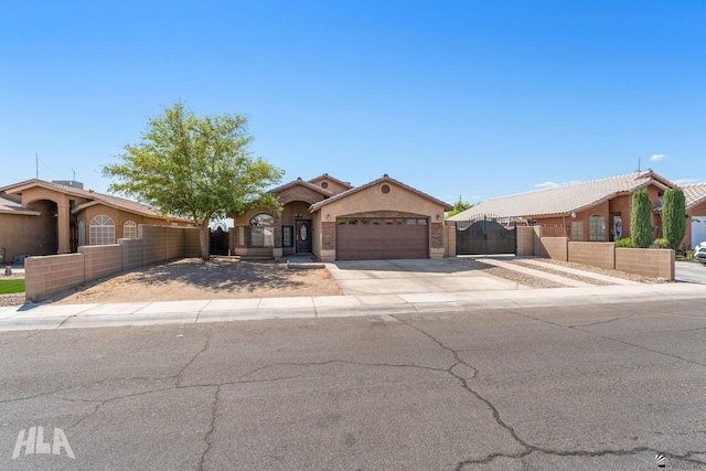 ranch-style home featuring fence, an attached garage, stucco siding, a gate, and driveway