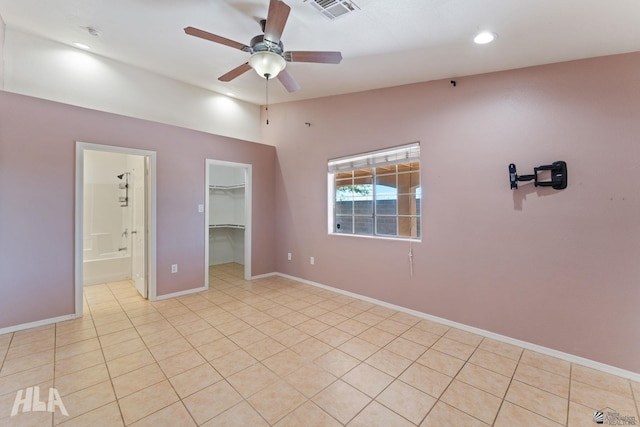 unfurnished room featuring visible vents, baseboards, a ceiling fan, light tile patterned floors, and vaulted ceiling