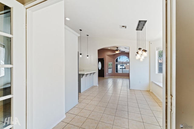 hall featuring visible vents, arched walkways, light tile patterned flooring, and recessed lighting