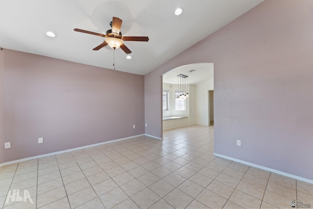 spare room with arched walkways, ceiling fan with notable chandelier, recessed lighting, light tile patterned floors, and lofted ceiling