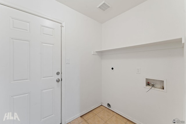 clothes washing area with baseboards, laundry area, visible vents, and washer hookup