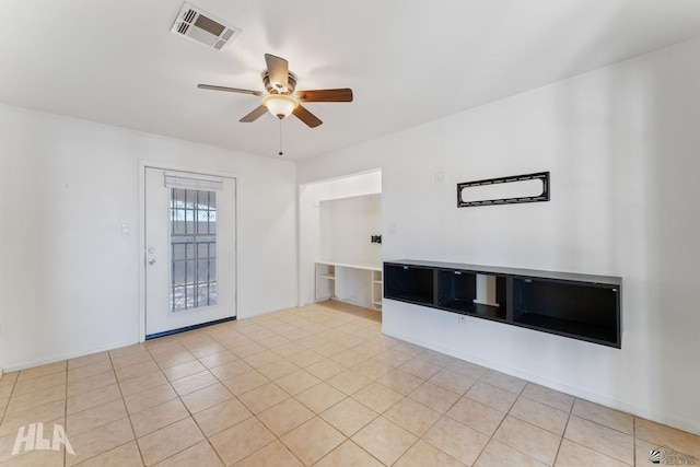 unfurnished living room featuring ceiling fan, visible vents, and light tile patterned floors