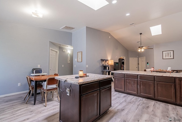 7309 E 37th Pl, Yuma, AZ 85365 - kitchen with a skylight, light wood-style floors, lofted ceiling, a ceiling fan, and dark brown cabinets