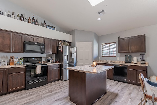 7309 E 37th Pl, Yuma, AZ 85365 - kitchen with black appliances, light countertops, dark brown cabinets, lofted ceiling, and light wood finished floors