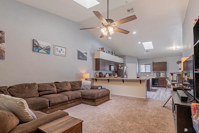 7309 E 37th Pl, Yuma, AZ 85365 - living area featuring a skylight, lofted ceiling, a ceiling fan, and light carpet