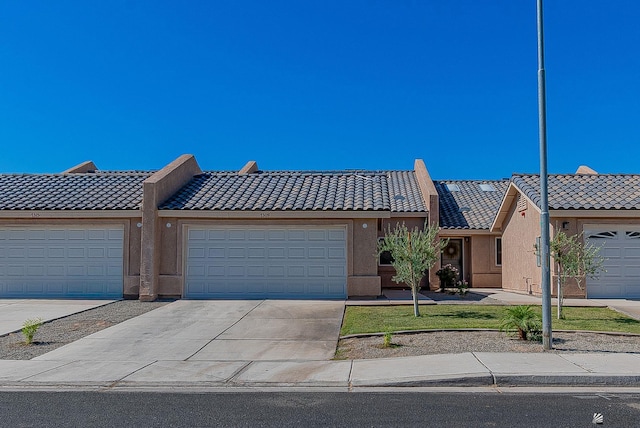 7309 E 37th Pl, Yuma, AZ 85365 - view of front of property with a tile roof, concrete driveway, stucco siding, and a front yard
