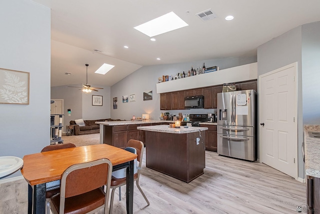 7309 E 37th Pl, Yuma, AZ 85365 - kitchen featuring black appliances, a skylight, dark brown cabinets, vaulted ceiling, and light wood-type flooring