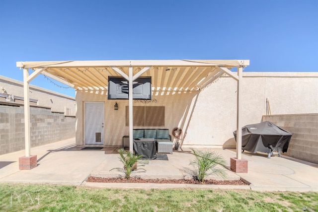 view of patio with fence and a grill