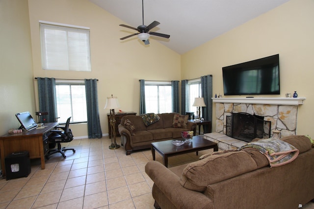 12459 E Del Rey Dr, Yuma, AZ 85367 - living room featuring a stone fireplace, baseboards, high vaulted ceiling, a ceiling fan, and light tile patterned floors