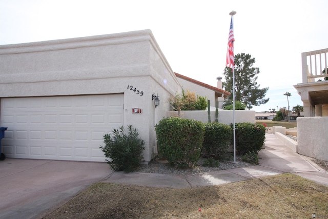 12459 E Del Rey Dr, Yuma, AZ 85367 - view of side of property with a garage, stucco siding, and concrete driveway