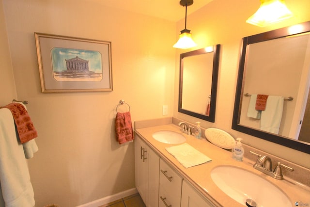 12459 E Del Rey Dr, Yuma, AZ 85367 - bathroom with double vanity, a sink, baseboards, and tile patterned flooring