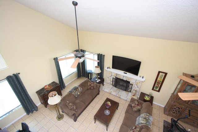 12459 E Del Rey Dr, Yuma, AZ 85367 - living area with tile patterned flooring, plenty of natural light, vaulted ceiling, and a stone fireplace