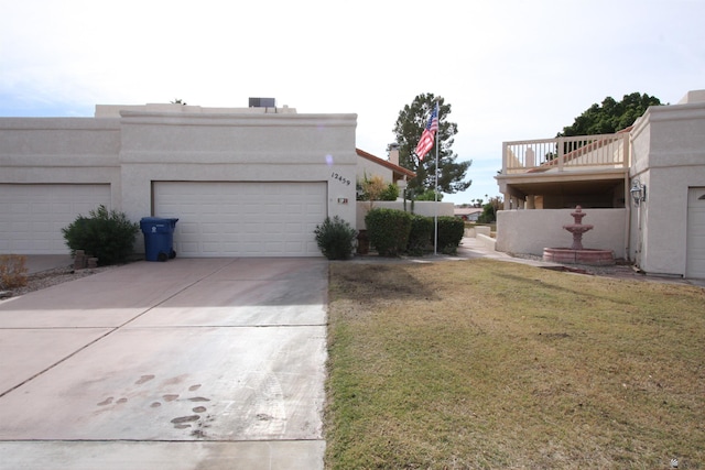 12459 E Del Rey Dr, Yuma, AZ 85367 - view of side of home featuring a balcony, driveway, stucco siding, an attached garage, and a yard