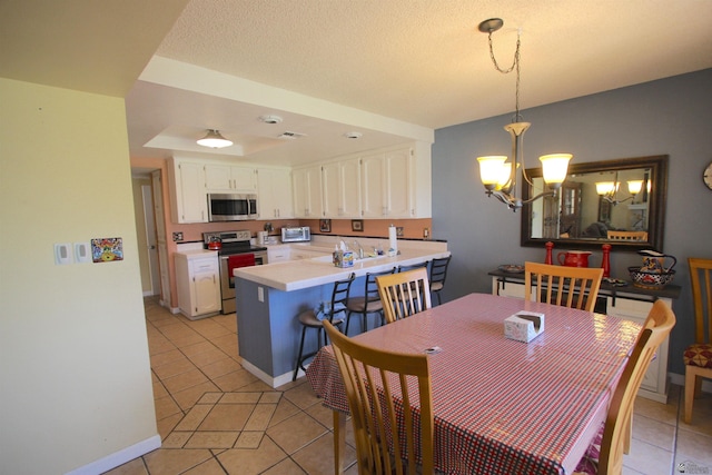 12459 E Del Rey Dr, Yuma, AZ 85367 - dining space with visible vents, a toaster, baseboards, light tile patterned floors, and a notable chandelier