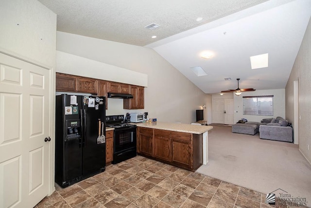 kitchen featuring black appliances, a peninsula, under cabinet range hood, lofted ceiling, and ceiling fan