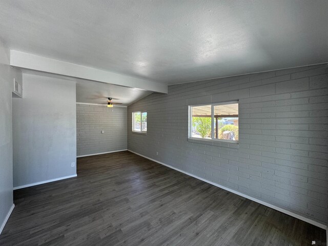 2641 S Las Palmas Vista Ave, Yuma, AZ 85364 - spare room featuring brick wall, baseboards, dark wood-style flooring, and ceiling fan