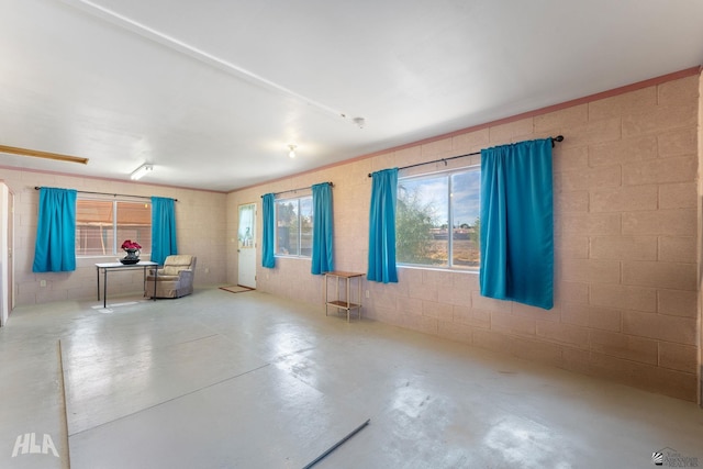 29433 San Jose Ave, Wellton, AZ 85356 - unfurnished living room with concrete flooring and concrete block wall
