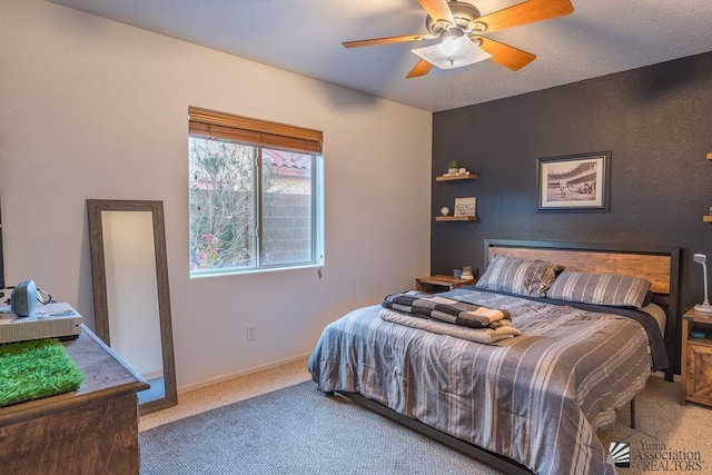 carpeted bedroom featuring a ceiling fan and baseboards