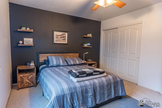 carpeted bedroom featuring baseboards, a ceiling fan, and a closet