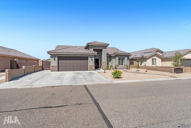 12590 E 48th Dr, Yuma, AZ 85367 - view of front of home with a garage, stucco siding, a tile roof, and driveway