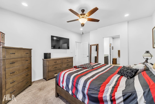 12590 E 48th Dr, Yuma, AZ 85367 - bedroom with light colored carpet, recessed lighting, ceiling fan, connected bathroom, and baseboards