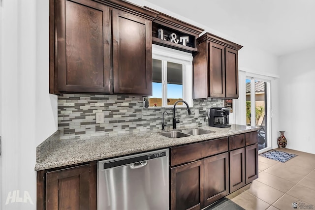 12590 E 48th Dr, Yuma, AZ 85367 - kitchen with stainless steel dishwasher, a sink, backsplash, dark brown cabinetry, and light stone countertops