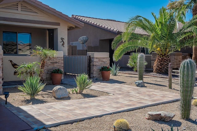 13743 E 45th Ln, Yuma, AZ 85367 - exterior space with fence, a tile roof, stone siding, stucco siding, and a gate