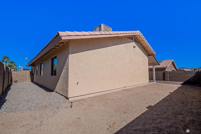 13743 E 45th Ln, Yuma, AZ 85367 - view of side of home featuring a fenced backyard, stucco siding, and a tile roof
