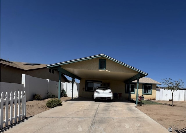 778 W Ramona St, Somerton, AZ 85350 - view of front of house featuring concrete driveway, stucco siding, fence, and a carport