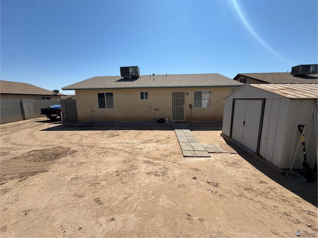 778 W Ramona St, Somerton, AZ 85350 - back of property featuring a storage shed, fence, cooling unit, an outdoor structure, and stucco siding
